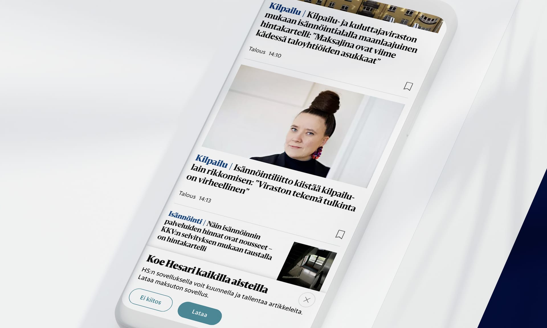 Finnish news website on a mobile phone showing articles about consumer protection and housing regulations.