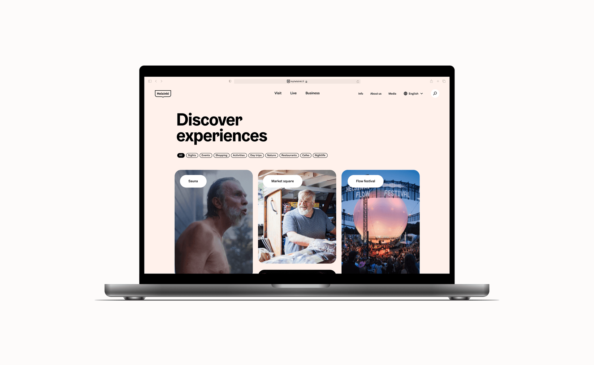 Laptop displaying Helsinki tourism website with "Discover experiences" section showing sauna, market square and Flow festival options.