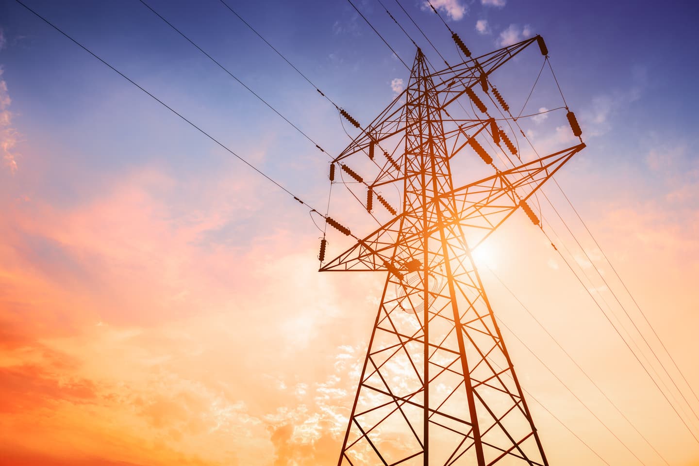 A transmission tower captured against the background of a colourful evening sky
